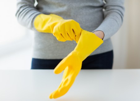 close up of woman wearing protective rubber gloves